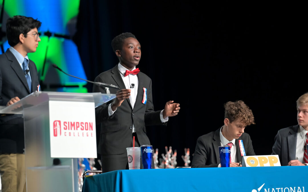 Students on stage competing at the National Speech and Debate National Tournament