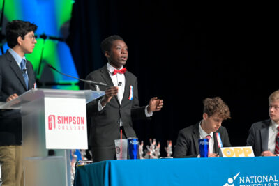 Students on stage competing at the National Speech and Debate National Tournament