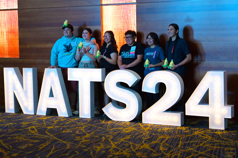 Group of students posing with NATS24 sign at the National Tournament